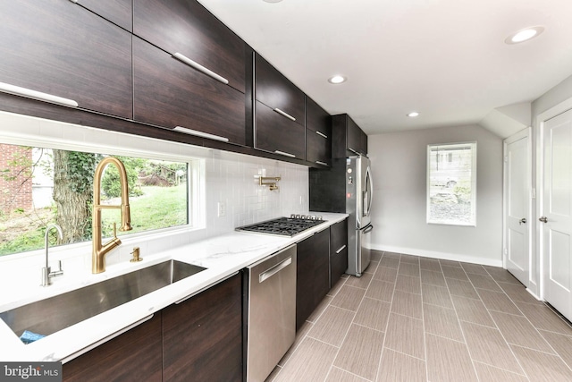 2432 S Culpeper St, Arlington, VA 22206 - kitchen featuring a sink, stainless steel appliances, modern cabinets, decorative backsplash, and baseboards