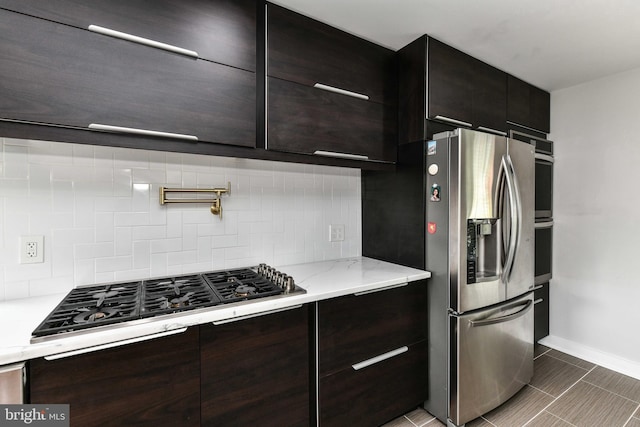 2432 S Culpeper St, Arlington, VA 22206 - kitchen featuring appliances with stainless steel finishes, decorative backsplash, modern cabinets, light stone countertops, and baseboards