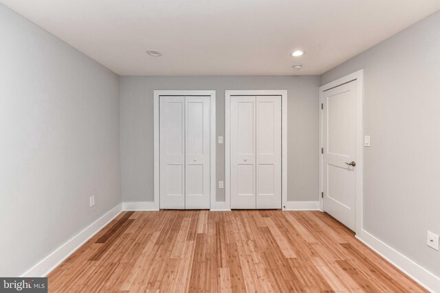 2432 S Culpeper St, Arlington, VA 22206 - unfurnished bedroom featuring two closets, baseboards, light wood finished floors, and recessed lighting