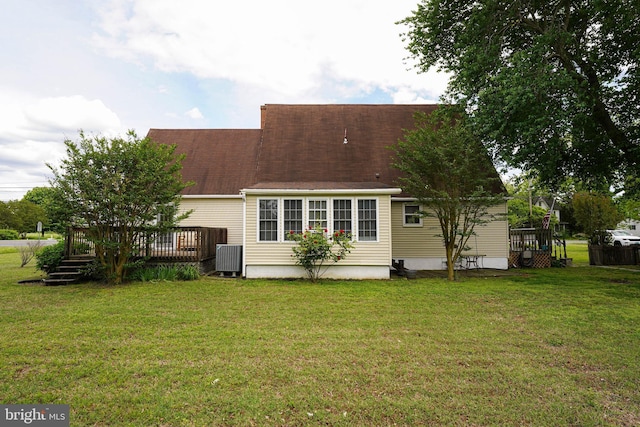 20560 Nanticoke Rd, Nanticoke, MD 21840 - rear view of house with a deck, a lawn, cooling unit, and roof with shingles