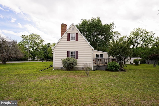 20560 Nanticoke Rd, Nanticoke, MD 21840 - view of side of home with a chimney, a wooden deck, and a lawn