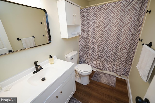 20560 Nanticoke Rd, Nanticoke, MD 21840 - bathroom featuring toilet, vanity, wood finished floors, and a shower with shower curtain