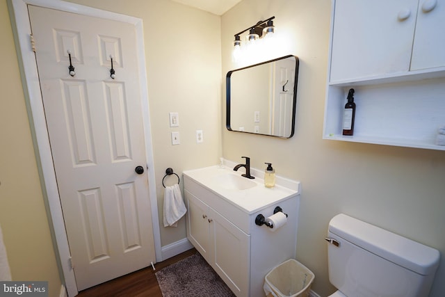 20560 Nanticoke Rd, Nanticoke, MD 21840 - half bathroom featuring vanity, toilet, and wood finished floors