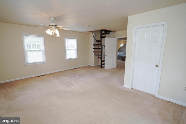 20560 Nanticoke Rd, Nanticoke, MD 21840 - spare room with stairs, light colored carpet, a ceiling fan, and baseboards