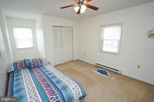 20560 Nanticoke Rd, Nanticoke, MD 21840 - bedroom featuring a baseboard heating unit, carpet, multiple windows, and a closet