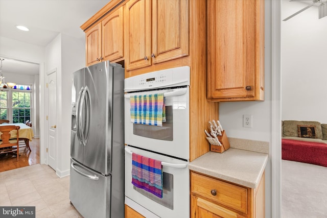 201 Henrys Mill Dr, Berlin, MD 21811 - kitchen featuring stainless steel fridge, double oven, light countertops, recessed lighting, and light tile patterned floors