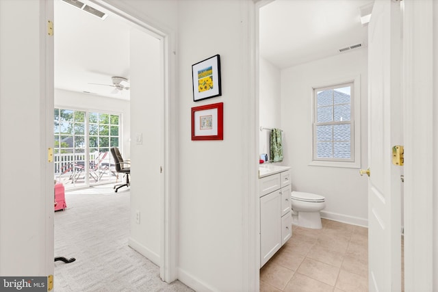 201 Henrys Mill Dr, Berlin, MD 21811 - bathroom with vanity, toilet, baseboards, a ceiling fan, and tile patterned flooring