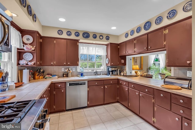 607 Rosedale Rd, Princeton, NJ 08540 - kitchen with stainless steel appliances, a sink, tile counters, open shelves, and backsplash