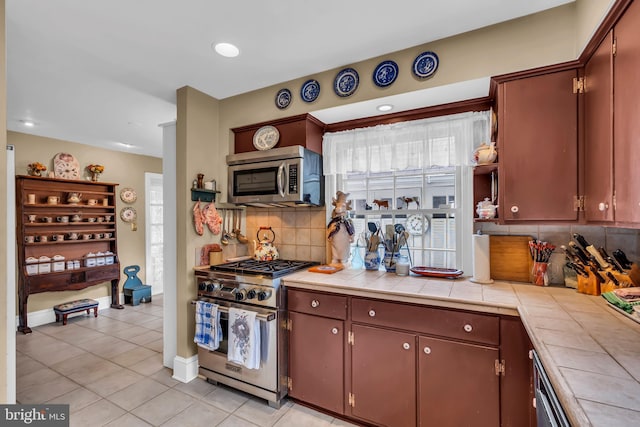 607 Rosedale Rd, Princeton, NJ 08540 - kitchen with appliances with stainless steel finishes, tile countertops, light tile patterned floors, tasteful backsplash, and recessed lighting
