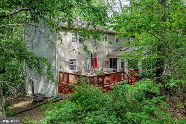 back of property with a deck and central AC unit