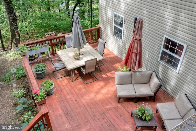 deck with outdoor dining area and an outdoor living space