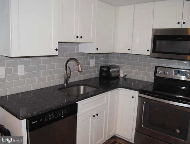 kitchen featuring stainless steel appliances, a sink, and white cabinetry