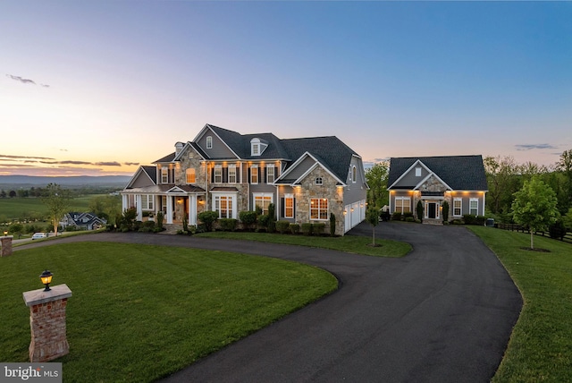 16024 Waterford Crest Pl, Paeonian Springs, VA 20129 - view of front of house with stone siding, curved driveway, a lawn, and a garage