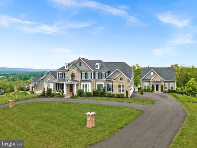 16024 Waterford Crest Pl, Paeonian Springs, VA 20129 - view of front of property featuring a standing seam roof, curved driveway, stone siding, a front yard, and metal roof