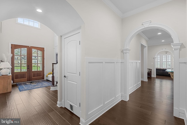 16024 Waterford Crest Pl, Paeonian Springs, VA 20129 - entryway featuring dark wood-style flooring, arched walkways, crown molding, a decorative wall, and french doors
