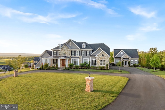 16024 Waterford Crest Pl, Paeonian Springs, VA 20129 - view of front of property featuring stone siding, a standing seam roof, a front lawn, driveway, and metal roof