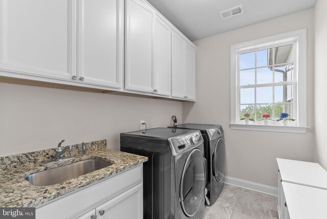 16024 Waterford Crest Pl, Paeonian Springs, VA 20129 - clothes washing area with cabinet space, washer and dryer, light marble finish flooring, and baseboards