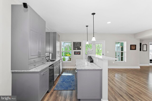 16024 Waterford Crest Pl, Paeonian Springs, VA 20129 - kitchen featuring gray cabinets, dark wood-style floors, baseboards, a sink, and a kitchen island