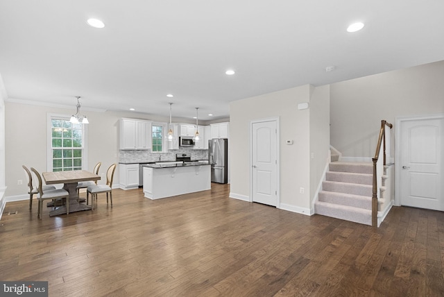 16024 Waterford Crest Pl, Paeonian Springs, VA 20129 - kitchen with stainless steel appliances, white cabinets, decorative backsplash, a kitchen island, and dark wood-style floors