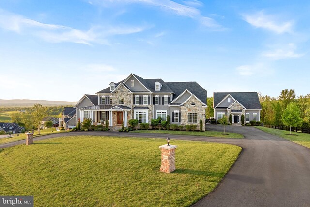 16024 Waterford Crest Pl, Paeonian Springs, VA 20129 - view of front of property featuring stone siding, a standing seam roof, a front lawn, driveway, and metal roof