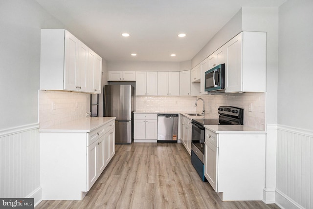 748 Jefferson St, Red Hill, PA 18076 - kitchen with appliances with stainless steel finishes, a sink, wainscoting, light wood finished floors, and recessed lighting