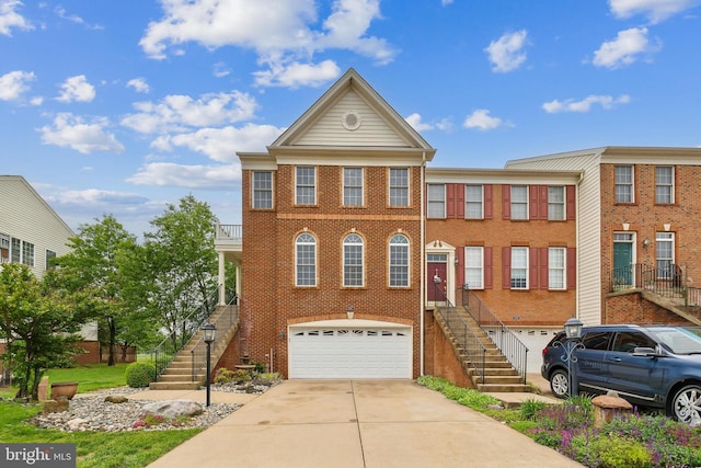 22615 Upperville Heights Sq, Ashburn, VA 20148 - view of front of property with stairs, an attached garage, concrete driveway, and brick siding