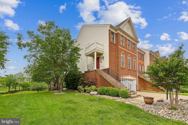 22615 Upperville Heights Sq, Ashburn, VA 20148 - view of home's exterior featuring a lawn, brick siding, and an attached garage