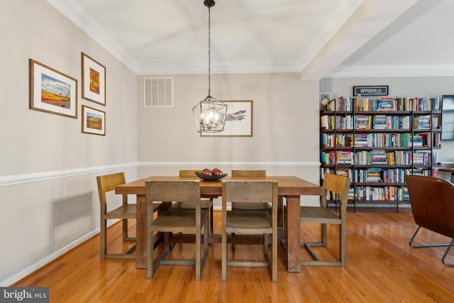 22615 Upperville Heights Sq, Ashburn, VA 20148 - dining space with a chandelier, wood finished floors, and crown molding