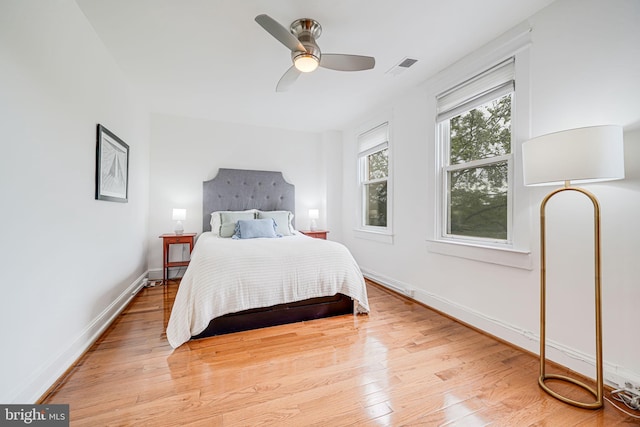 bedroom with wood finished floors, baseboards, and ceiling fan