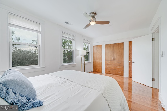 bedroom with light wood-style flooring and a ceiling fan