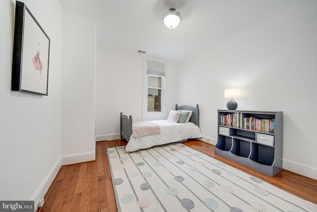 bedroom with wood finished floors and baseboards
