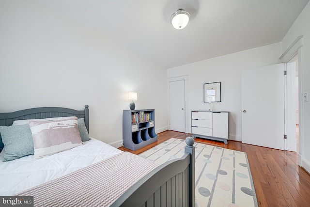 bedroom featuring wood finished floors and baseboards