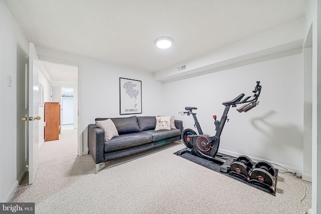 exercise room with carpet floors and baseboards