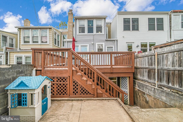 rear view of house with a deck, stairway, and a patio
