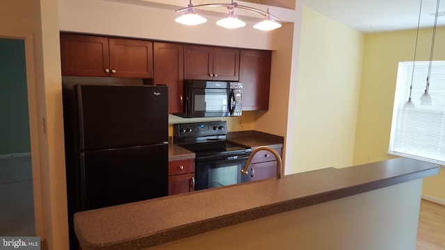 2400 Dominion Dr Unit 3D, Frederick, MD 21702 - kitchen featuring black appliances, a sink, light wood-type flooring, and dark countertops