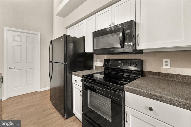 2400 Dominion Dr Unit 3D, Frederick, MD 21702 - kitchen featuring black appliances, dark countertops, white cabinetry, light wood-type flooring, and baseboards