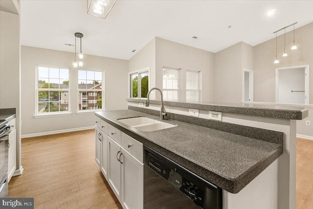 2400 Dominion Dr Unit 3D, Frederick, MD 21702 - kitchen featuring black dishwasher, a sink, a center island with sink, light wood-style flooring, and hanging light fixtures