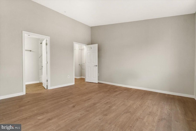 2400 Dominion Dr Unit 3D, Frederick, MD 21702 - unfurnished bedroom with a walk in closet, wood finished floors, baseboards, and a closet