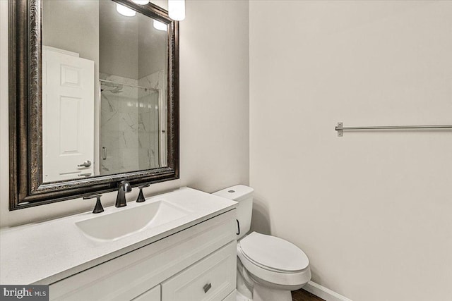2400 Dominion Dr Unit 3D, Frederick, MD 21702 - bathroom featuring a marble finish shower, toilet, vanity, and baseboards