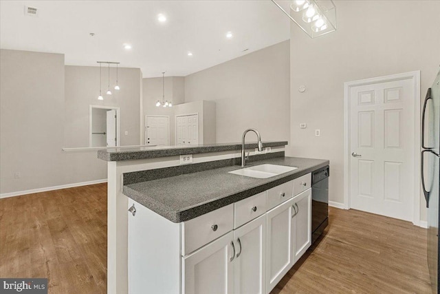 2400 Dominion Dr Unit 3D, Frederick, MD 21702 - kitchen with a sink, dishwasher, dark countertops, white cabinetry, and wood finished floors