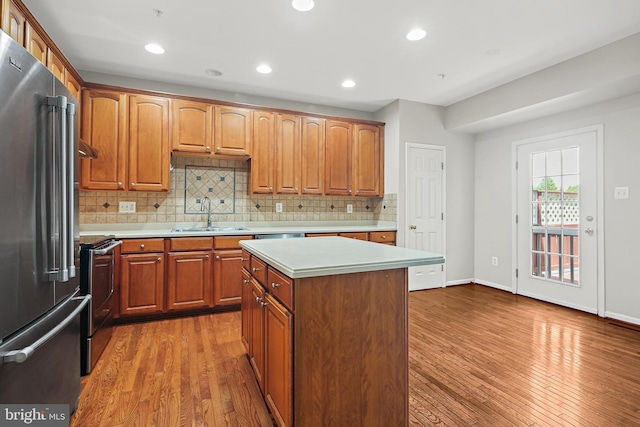10016 Love Song Ct, Laurel, MD 20723 - kitchen with appliances with stainless steel finishes, a sink, light countertops, wood finished floors, and recessed lighting