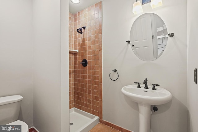 10016 Love Song Ct, Laurel, MD 20723 - bathroom featuring tiled shower, toilet, tile patterned floors, and baseboards
