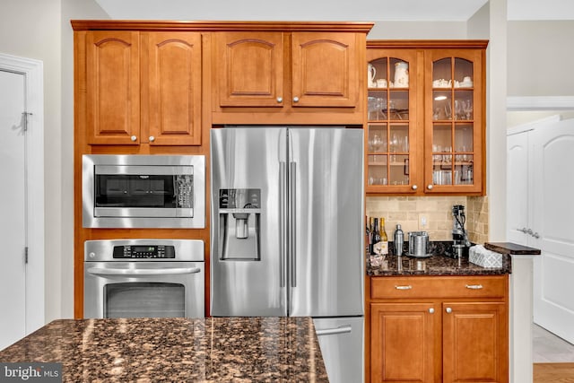 2906 Cornus Way, Joppa, MD 21085 - kitchen featuring appliances with stainless steel finishes, dark stone counters, and brown cabinetry