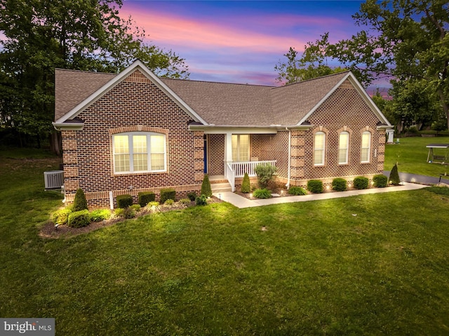 2906 Cornus Way, Joppa, MD 21085 - view of front of house featuring brick siding, a shingled roof, a lawn, and central AC