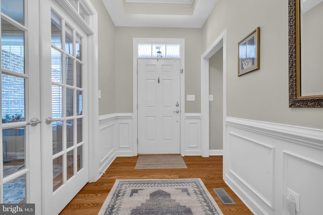 2906 Cornus Way, Joppa, MD 21085 - entrance foyer featuring a wainscoted wall, a decorative wall, wood finished floors, and french doors