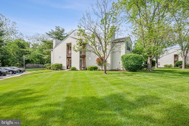 23 Village Ln Building 3 # 23A, Mount Laurel, NJ 08054 - view of front of house featuring a chimney, a front yard, and uncovered parking
