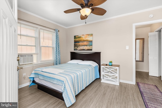 1004 Philadelphia Ave, Ocean City, MD 21842 - bedroom with baseboards, wood finished floors, crown molding, cooling unit, and a ceiling fan