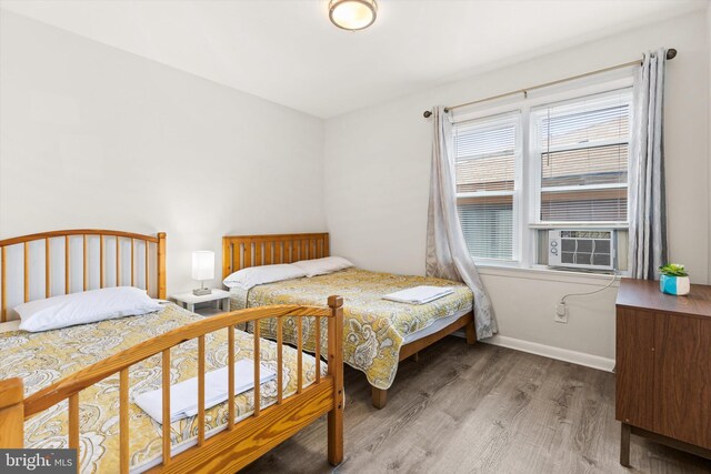 1004 Philadelphia Ave, Ocean City, MD 21842 - bedroom featuring wood finished floors, cooling unit, and baseboards