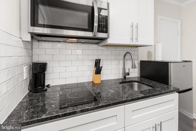 1004 Philadelphia Ave, Ocean City, MD 21842 - kitchen with stainless steel appliances, a sink, white cabinetry, ornamental molding, and decorative backsplash
