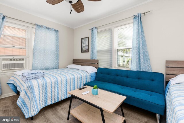 1004 Philadelphia Ave, Ocean City, MD 21842 - bedroom featuring cooling unit, wood finished floors, a ceiling fan, and ornamental molding
